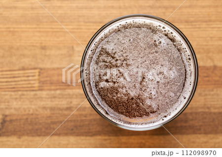 Craft beer in pint glass on a wooden table Craft beer in pint glass on a wooden table 112098970