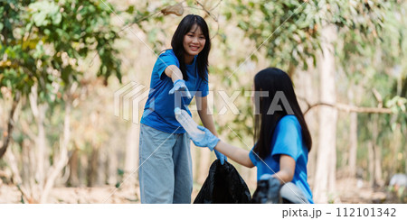 Group of volunteers, community members cleaning the nature from garbage and plastic waste to send it for recycling 112101342