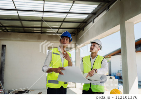 team engineer, foreman, architect meeting for colleagues discussing and checks construction blueprints at onsite team engineer, foreman, architect meeting for colleagues discussing and checks construction blueprints at onsite 112101376