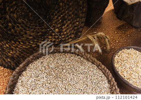 Rye grains lie in a basket and clay bowl Rye grains lie in a basket and clay bowl 112101424