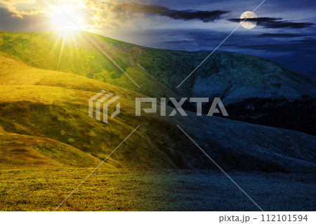 alpine meadow on the top of carpathian mountain range with sun and moon at summer solstice. day and night time change concept. mysterious nature scenery in morning light alpine meadow on the top of carpathian mountain range with sun and moon at summer solstice. day and night time change concept. mysterious nature scenery in morning light 112101594