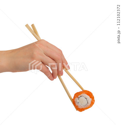 Hand with chopsticks taking philadelphia roll, sushi, isolated on white Hand with chopsticks taking philadelphia roll, sushi, isolated on white 112102372