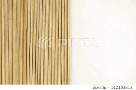 Bamboo sticks on a white background. Top view. Bamboo background for your product design. Bamboo sticks on a white background. Top view. Bamboo background for your product design. 112103818