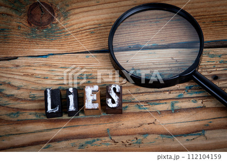 LIES. Alphabet letters on wood texture background LIES. Alphabet letters on wood texture background 112104159