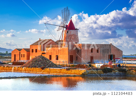 Marsala, Italy. Stagnone Lagoon with vintage windmills and saltwork, Trapani province, Sicily. Marsala, Italy. Stagnone Lagoon with vintage windmills and saltwork, Trapani province, Sicily. 112104483