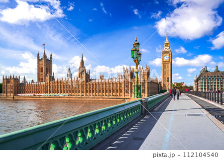 London, United Kingdom. Big Ben and Parliament Building, beautiful blue sky with white clouds. 112104540