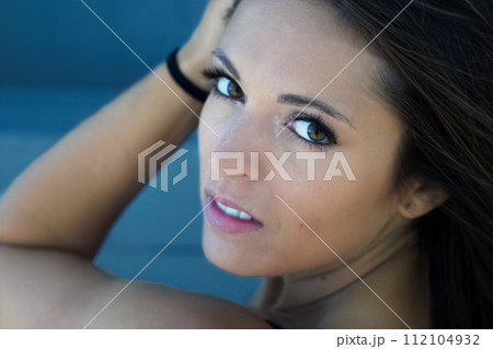 young woman portrait close-up face arm hand in hairs makeup style brunette young woman portrait close-up face arm hand in hairs makeup style brunette 112104932