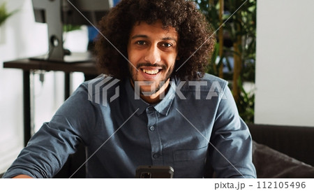 Employee analyzing statistics data on smartphone, browsing online phone app in office. Marketing specialist planning project with analytics and annual information, small business. Handheld shot. 112105496