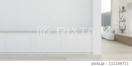 The interior design of a modern home corridor with a white wall with molding and a parquet floor. 112109711