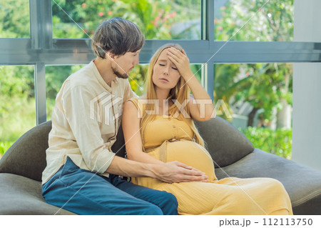 Expectant woman feels unwell, husband comforts and reassures her during a challenging pregnancy Expectant woman feels unwell, husband comforts and reassures her during a challenging pregnancy 112113750