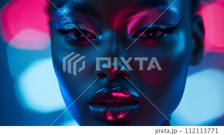 An intense close-up portrait of a woman with striking neon makeup, her features illuminated by dynamic blue and pink lights 112113771