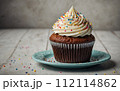 Delicious birthday cupcake on the table 112114862