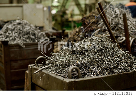Selective focus no people shot of metal shavings in containers in workshop, copy space 112115015