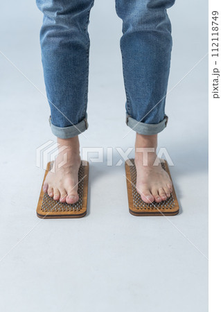 Sadhu board, yoga board with nails, guy stands on the board with nails, yoga concept Sadhu board, yoga board with nails, guy stands on the board with nails, yoga concept 112118749