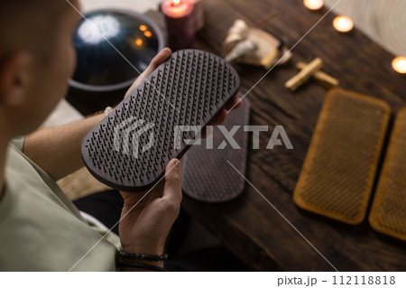 Sadhu board, yoga board with nails, guy stands on the board with nails, yoga concept Sadhu board, yoga board with nails, guy stands on the board with nails, yoga concept 112118818