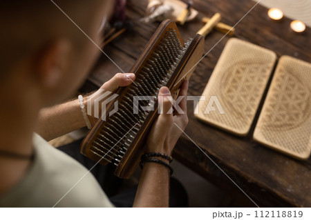 Sadhu board, yoga board with nails, guy stands on the board with nails, yoga concept Sadhu board, yoga board with nails, guy stands on the board with nails, yoga concept 112118819