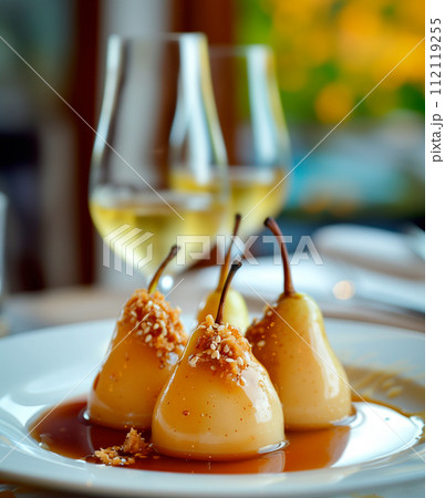 Paleo style dessert poached pear dessert pashot. Pear caramelized in syrup on a wooden plate 112119255