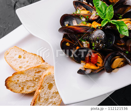 Delicious seafood mussels with with sauce and parsley 112121536
