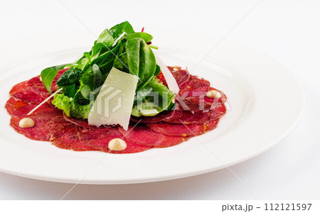 Beef carpaccio with parmesan cheese close up Beef carpaccio with parmesan cheese close up 112121597
