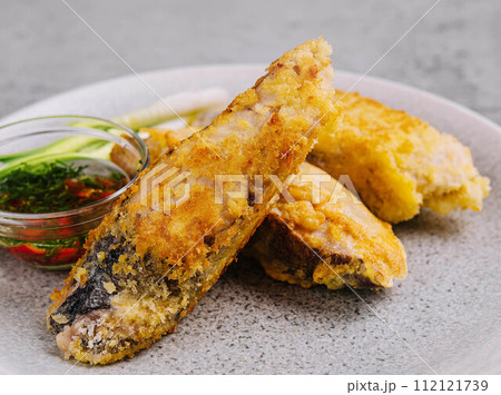 close up fried fish fillet with vegetables 112121739