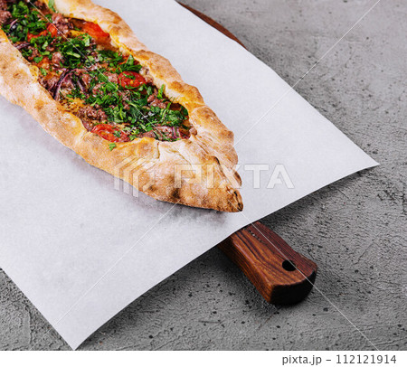 traditional turkish meat pide on wooden board traditional turkish meat pide on wooden board 112121914
