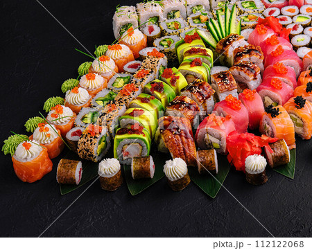 Large sushi set, shot from the top on a black background Large sushi set, shot from the top on a black background 112122068