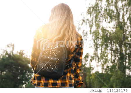 Backpack woman. Hipster girl with backpack in woods. Traveler ba Backpack woman. Hipster girl with backpack in woods. Traveler ba 112122175