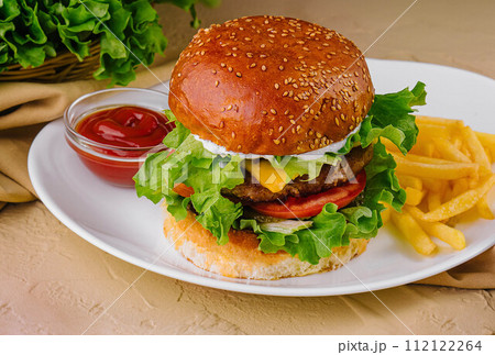 burgers with french fries served on plates 112122264