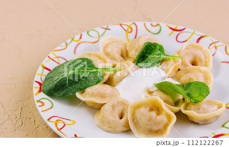 Boiled dumplings with basil on plate Boiled dumplings with basil on plate 112122267