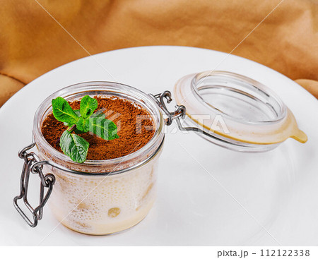 tiramisu in a glass jar top view 112122338