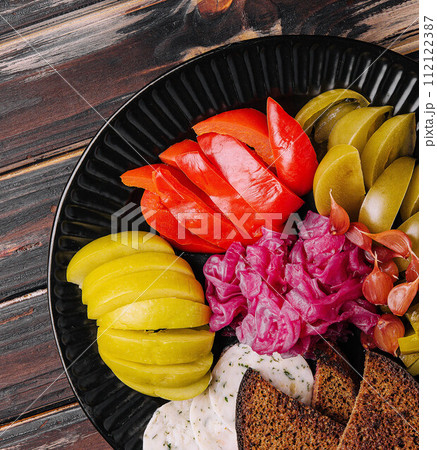 Delicious spicy pickles cut on a serving plate Delicious spicy pickles cut on a serving plate 112122387
