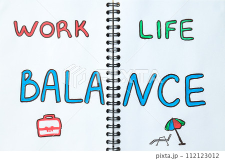 Concept of work-life balance, writing in notebook. Concept of work-life balance, writing in notebook. 112123012