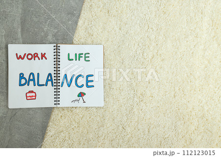 Concept of work-life balance, writing in notebook. Concept of work-life balance, writing in notebook. 112123015