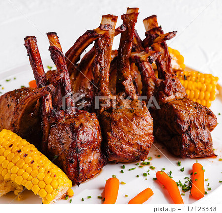 rack of lamb with corn and carrots rack of lamb with corn and carrots 112123338