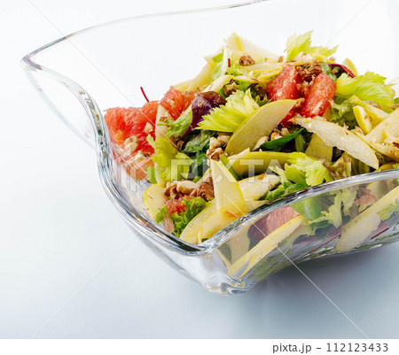 Plate with tasty grapefruit salad on white background Plate with tasty grapefruit salad on white background 112123433