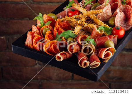 Traditional spanish jamon, prosciutto crudo, italian salami, parma ham 112123435