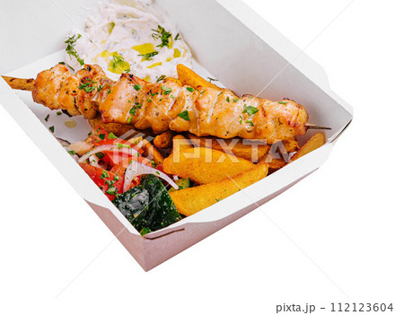 Chicken skewers with potatoes and tomato and onion salad Chicken skewers with potatoes and tomato and onion salad 112123604