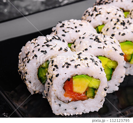 Delicious avocado sushi roll with salmon 112123795