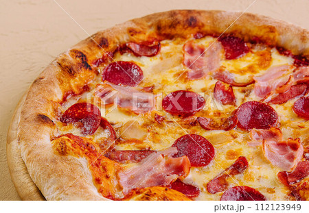 pepperoni pizza with ham on wood pepperoni pizza with ham on wood 112123949