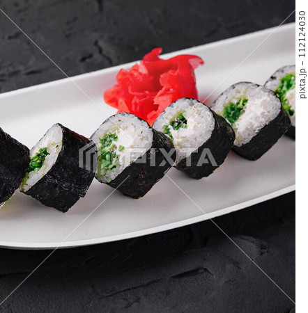 Maki Sushi with Spring Onion inside on plate Maki Sushi with Spring Onion inside on plate 112124030