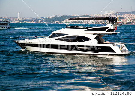 Luxury yacht boat cruising in the clean and deep blue waters of the Bosphorus, in Istanbul Turkey Luxury yacht boat cruising in the clean and deep blue waters of the Bosphorus, in Istanbul Turkey 112124280