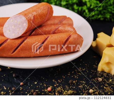 boiled sausages with cheese on plate 112124831