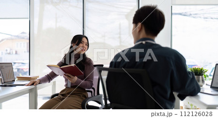Business team working using laptop computer sitting at table. colleague company discussing data management using laptop compute at consulting Business team working using laptop computer sitting at table. colleague company discussing data management using laptop compute at consulting 112126028