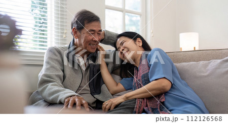 Happy mature husband and wife sit rest on comfortable sofa in living room enjoy talking, smiling elderly couple relax on couch at home chat speak laugh on leisure weekend Happy mature husband and wife sit rest on comfortable sofa in living room enjoy talking, smiling elderly couple relax on couch at home chat speak laugh on leisure weekend 112126568