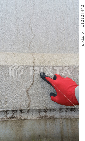 外壁のひび割れ・目地の劣化を点検する作業員 112127442