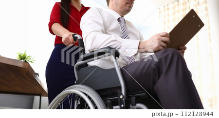 Disabled male preparing report 112128944