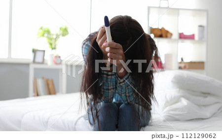 Girl sitting at home upset because pregnancy test 112129062