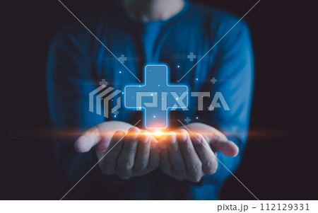 Healthcare insurance and medicine concept. Businessman holding virtual blue plus sign for positive thinking mindset or healthcare insurance symbol, Mental health care, mental rejuvenation. 112129331