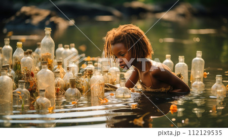 Poor, beggar, hungry dark-skinned child girl in Africa, washing dishes in a dirty river, anti-sanitation. 112129535