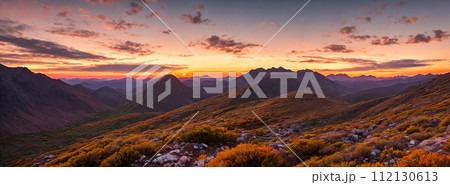 Rugged beauty of a mountain range at golden hour, with the sun setting in the background 112130613